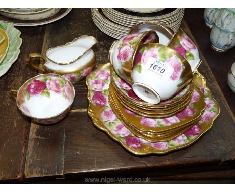 A Royal Albert ''English Roses'' gilded version part Teaset comprising give cups, six saucers, six tea plates, cake plate and