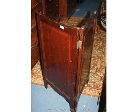 A two leaf Mahogany Firescreen having raised and fielded panels and reflective metal inner surface, 38 1/2'' high x 20'' wide