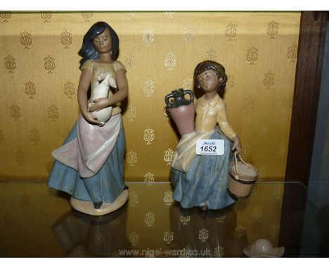 Two matt Nao figures of a young girl carrying water and another holding a rabbit.