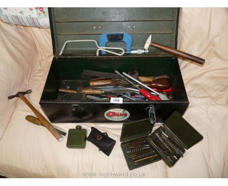 A metal box containing tools, boxes of gun cleaning brushes, etc.