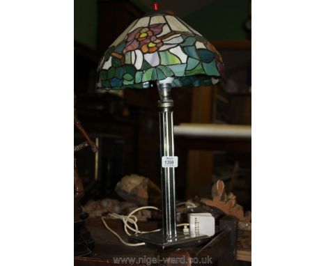 A vintage chrome table Lamp with a Tiffany style shade.