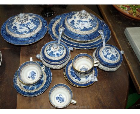 A quantity of Booths 'Old Willow' china including two meat plates, sauce tureens and ladles, vegetable dish and lid, cups and