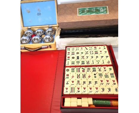 A Mahjong set with racks and a boule set.