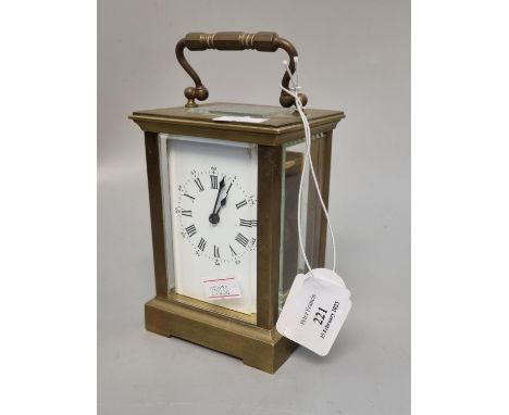 Early 20th century brass carriage clock with enamel face and Roman numerals, with key.  (B.P. 21% + VAT) 