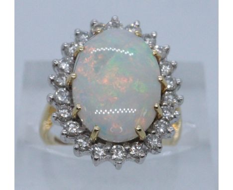 18ct gold opal and diamond dress ring. Size H + 1/2, 5.8g approx. Cased. (B.P. 21% + VAT)Condition is good, no obvious damage