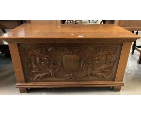 An early 20th century solid oak possibly presentation chest/trunk, ornately carved three panels with shield, dragons and foli