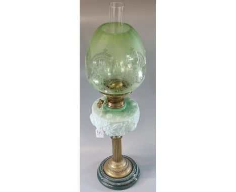 Early 20th Century double oil burner lamp having green and clear etched glass shade above a green moulded reservoir, standing