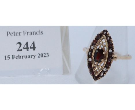 Yellow metal garnet set pierced navette shaped dress ring. Ring size V. 5.2g approx. Cased.(B.P. 21% + VAT) 