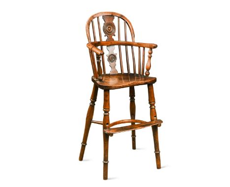 A yew and elm child's Windsor high chair, 19th century, the stick back with central solid splat over a saddle shaped seat on 