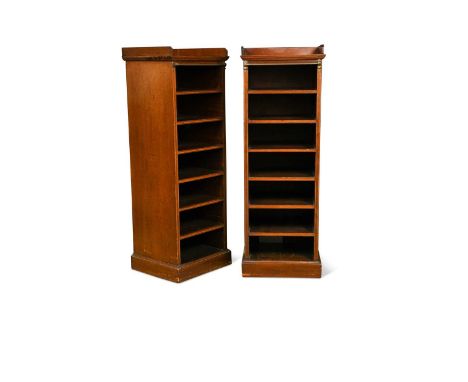 A pair of Edwardian narrow mahogany music cabinets, each with three quarter galleried tops, the fronts with brass tubular rai