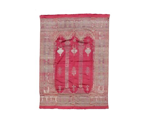 An Ottoman red silk and woven prayer hanging, 19th century,  centred by three slim mirhabs with chain hung mosque lamps, with