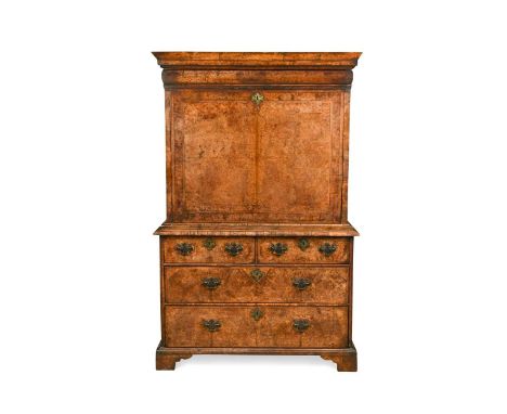 A walnut escritoire, early 18th century, the moulded cornice above a cushion moulded drawer and fall front, enclosing a fitte