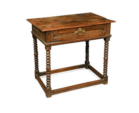 An oak and walnut side table, late 17th century, the rectangular top over a moulded frieze with single long drawer raised on 