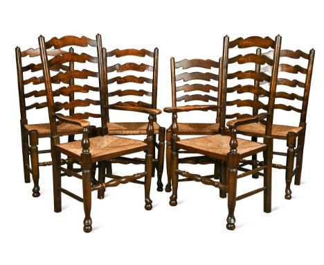 A set of eight ash ladder back chairs with rush seats, 20th century, to include two carvers and six chairs113 x 62 x 51cm