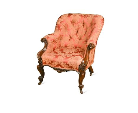 A mid Victorian carved rosewood and button backed armchair,  upholstered in Morris crimson floral silk, on cabriole legs81 x 