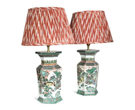 A pair of famille verte porcelain vases, late Qing Dynasty, of hexagonal form and decorated with scenes of warriors in combat