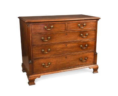 A George III mahogany chest of drawers, with two short over three long graduated drawers flanked by canted pilasters on ogee 