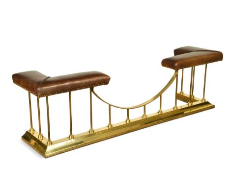 A brass club fender, late 20th century, the pair of brown faux leather padded seats on tubular supports49 x 161 x 40cminterna