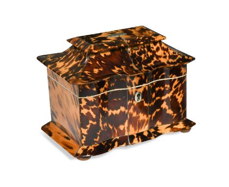 A Regency tortoiseshell tea caddy,  with serpentine shaped front, the hinged lid opening to reveal two ivory framed lidded co