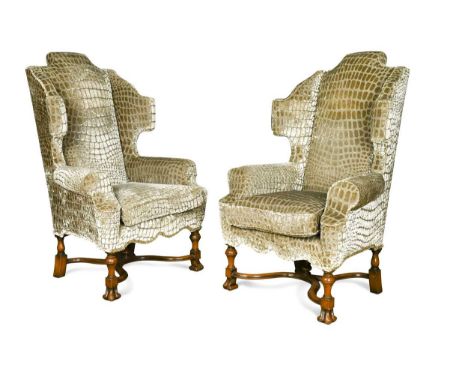 A large pair of William & Mary style wing back armchairs, 20th century, with arched backs and outscrolling arms raised on bra