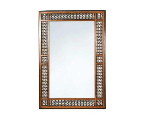 A large walnut and ebonised Liberty style wall mirror, circa 1900,  inset with masrabiya panels, inscribed to the reverse 'R.