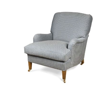A Bayswater easy armchair by Lorfords Contemporary, on tapering legs with brass castors, upholstered in Susa, White on Indigo