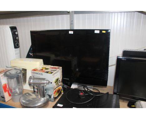 A Samsung flat screen television with remote control and instruction manual 