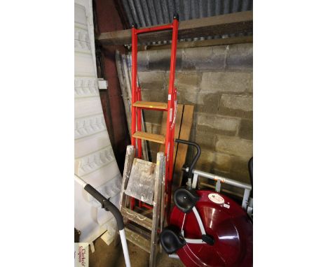 A metal folding five step ladder and a wooden folding three stepladder