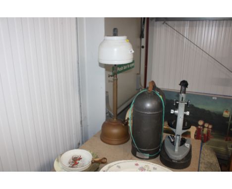 A pressure paraffin lamp with milk glass shade