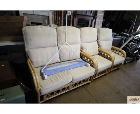 A bamboo conservatory set comprising two seater settee / sofa and two armchairs with cushions 