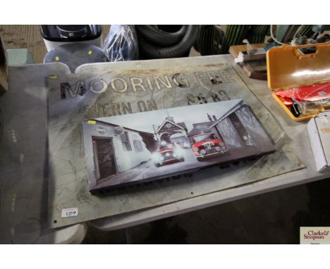 A canvas print of Mini Coopers and a sign for mooring fees