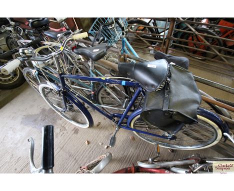 A men's Raleigh Wayfarer road bicycle with front headlamp, front and rear mud guards and rear panier rack 