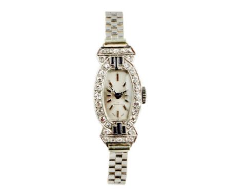 The case a tonnou shaped piece with unusual deco style lugs all made in platinum with 32 diamonds with an estimated total wei