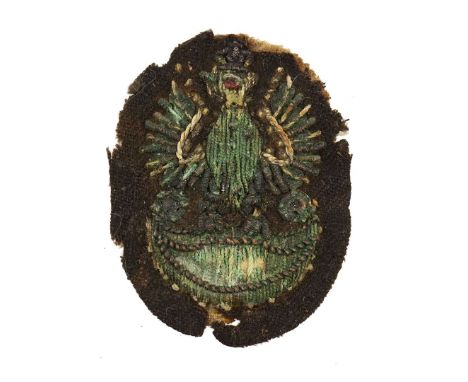Patch in a form of an eagle with spread wings sitting on an amazon shield, embroided with bullion thread. The head is topped 