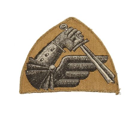 A triangular shaped Polish patch in the form of an armoured arm holding a sword, emblem of the 2nd Warsaw Armoured Division, 