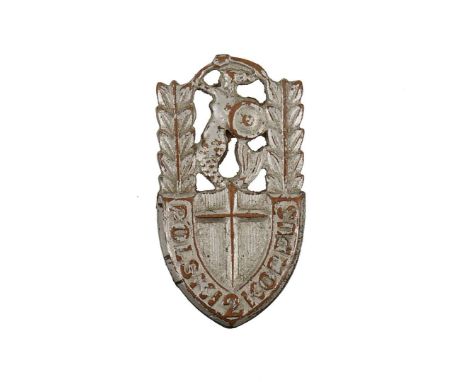 One-piece badge made of tombac, mounted on a cap. A badge in the form of a shield, the Warsaw mermaid in the upper part, the 