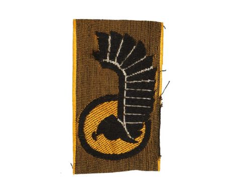 Rectangle khaki cloth patch. On the orange round shield, framed by a black border, a hussar helmet and hussar’s wings are ins