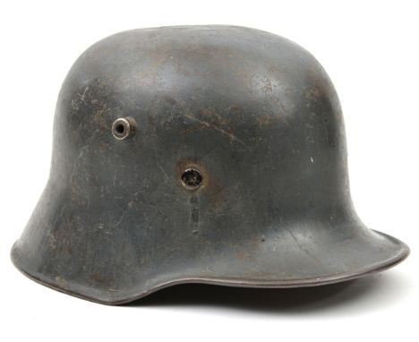 A WWI Imperial German steel helmet,  leather lining, field grey finish. GC (old repair to top of crown, 1 lining rivet missin