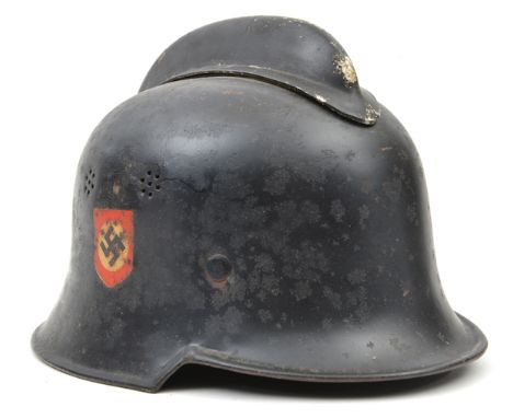 A Third Reich fire service steel helmet,  retains original decals, black finish rather pitted, GC  