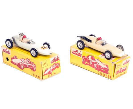 2 Solido F1 single seater racing cars. A BRM V8 in white, RN10. A Cooper 1500 in cream, no racing number. Both boxed, light w