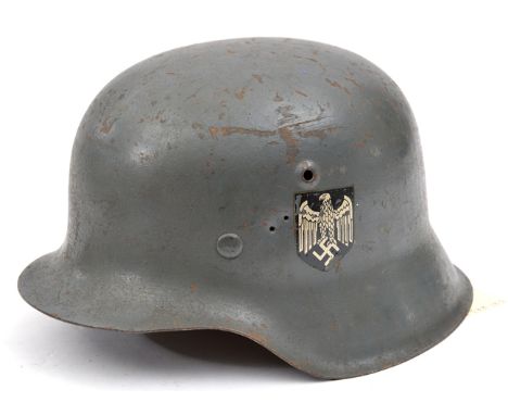 A Third Reich M1943 steel helmet,  original field grey finish and single decal. GC (2 small holes by decal) 