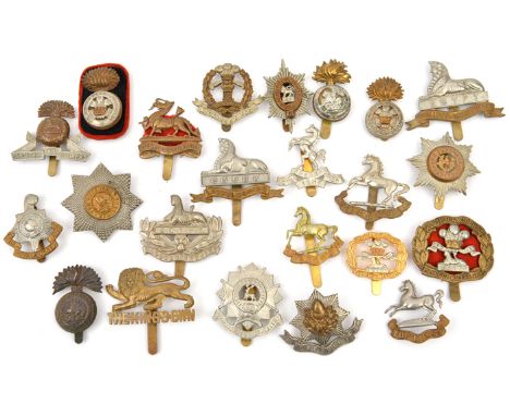 23 different infantry cap badges, including Northumberland Fus brass and bi-metal, Kings Roman and Gothic large and small, Li
