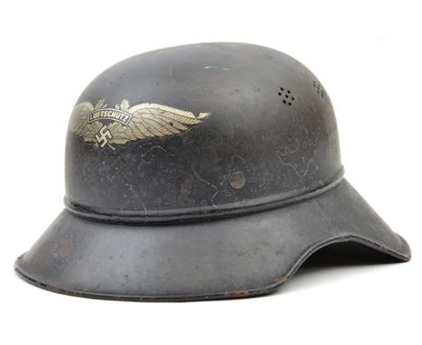 A Third Reich Luftschutz Bund wardens steel helmet, still retains original decal, chin strap and internal markings. GC (inter
