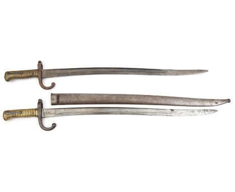 A Chassepot bayonet in its scabbard, blade unmarked; another Chassepot with German proof marks. GC (screw missing from second