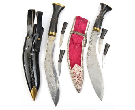 A kukri,  plain black hilt, in red velvet scabbard, panelled overall on the outer side with pierced and embossed ornamental p