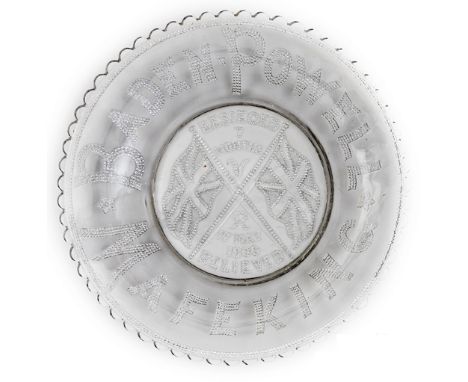 A commemorative glass plate beaded inscription “Baden Powell” and Mafeking around the rim, in the centre a stand of flags and