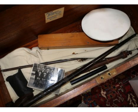 A naval trunk containing a naval cap, epaulettes, a nautical ruler, sword stick and truncheon.