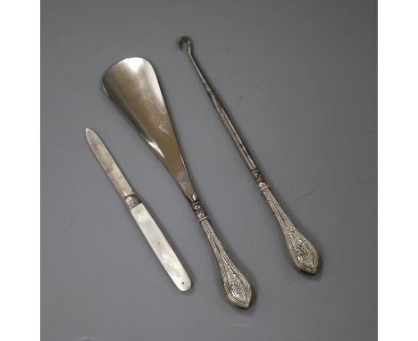 An early 20th century silver handled shoe horn and button hook and a silver mother of pearl fruit knife.