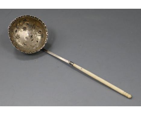 A continental white metal ladle, with embossed bowl and turned handle, 22cm.