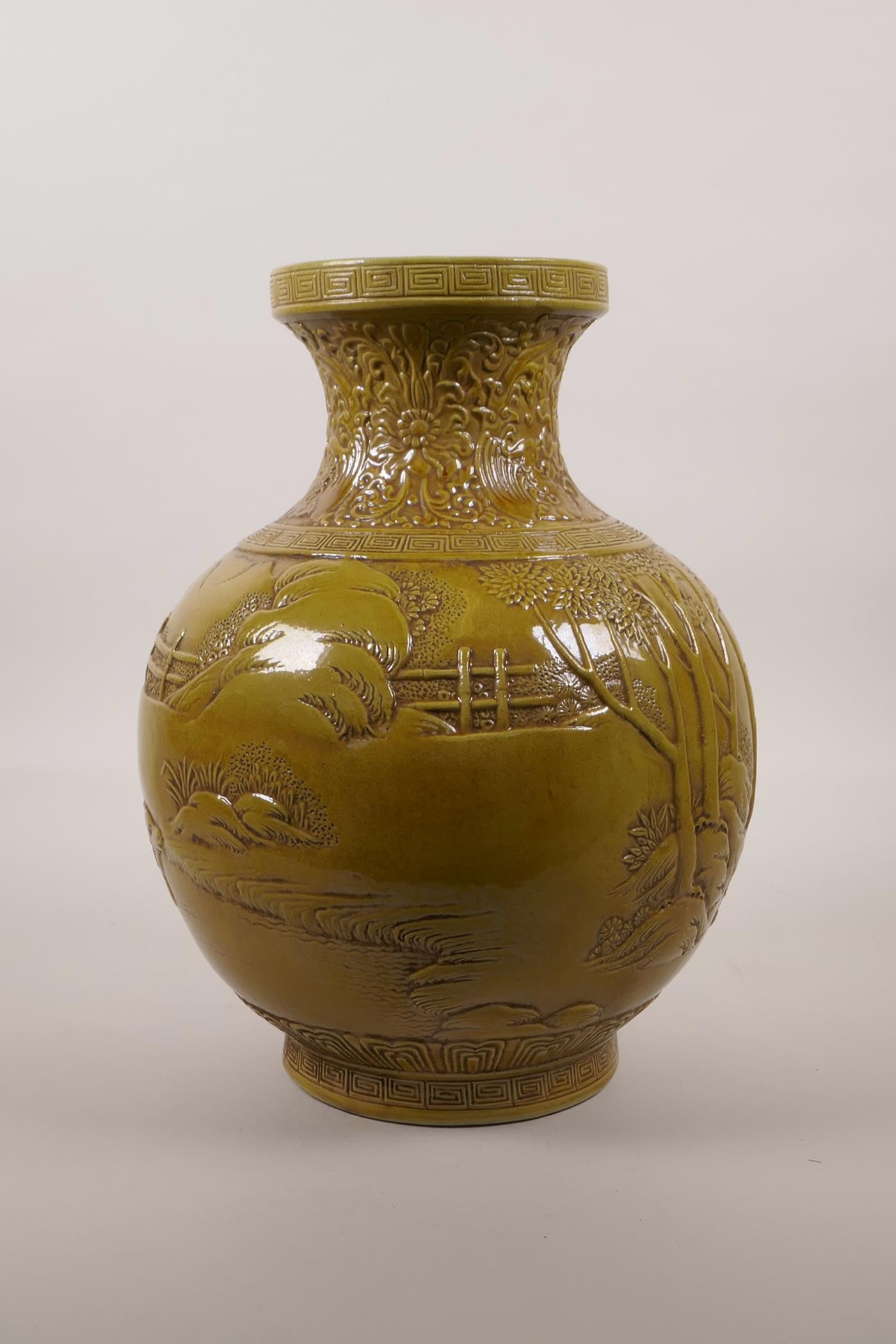 A large Chinese ochre glazed pottery vase with raised decoration of